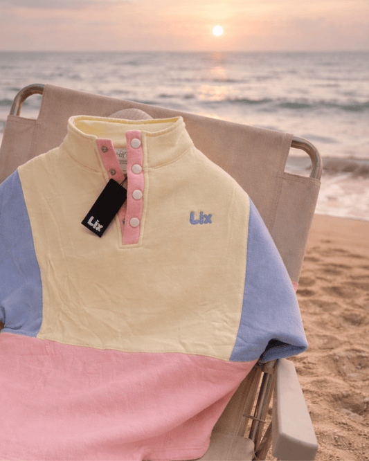 Crewneck colorblock jaune, rose et bleu avec ajustement à la taille.