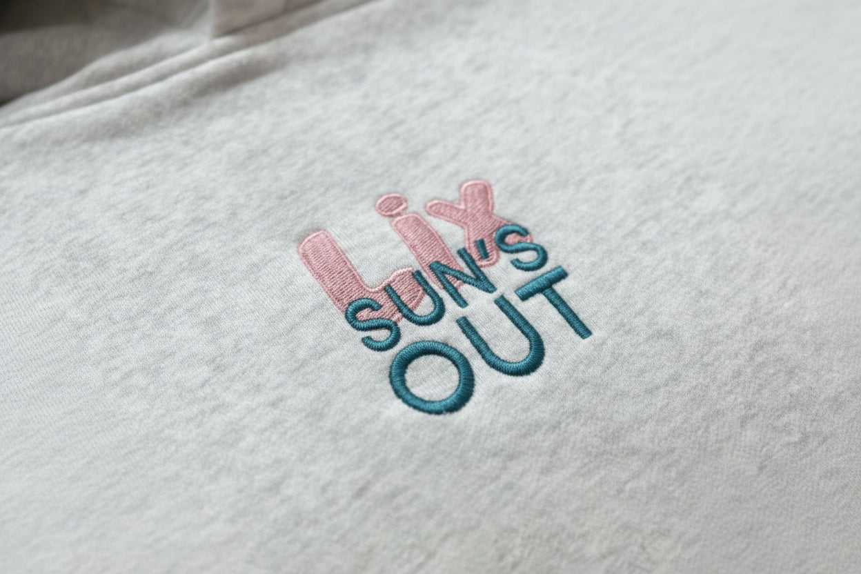 Hoodie gris avec broderie lix rose et sun's out bleu.