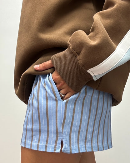 Short bleu avec rayure brune. Poche sur les côtés.  Tissu non transparent confortable pour femme. 